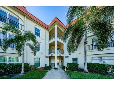 Two-story condo building with palm trees and walkway at 2700 Bayshore Blvd # 4309, Dunedin, FL 34698