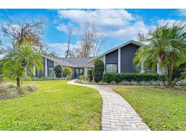 Beautiful home exterior with landscaped yard and walkway at 105 Locust Dr, Brandon, FL 33511