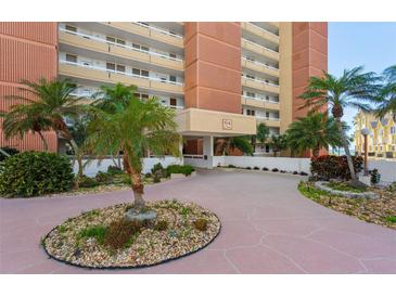 Attractive building exterior with palm trees and a courtyard at 17940 Gulf Blvd # 15C, Redington Shores, FL 33708