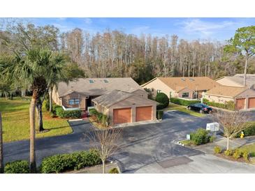 Attractive villa with a two-car garage and lush landscaping at 3185 Charter Club Dr # A, Tarpon Springs, FL 34688