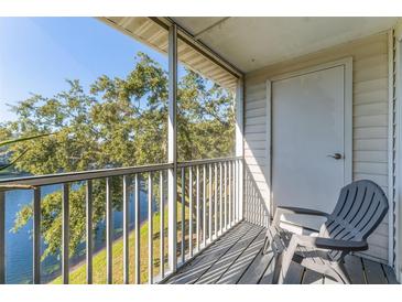 Private screened balcony overlooking a lake, offering tranquility and outdoor space at 3300 Haviland Ct # 303, Palm Harbor, FL 34684
