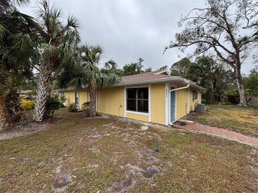 Cute yellow house with palm trees and a brick walkway at 4651 Summerwind Dr # 26, Sarasota, FL 34234