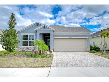 Curb appeal abounds in this charming one-story home featuring a paver driveway and landscaped yard at 6112 Plover Meadow St, Lithia, FL 33547