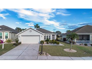 Single-story home with attached garage and landscaped front yard at 1112 Jasmine Creek Ct, Sun City Center, FL 33573