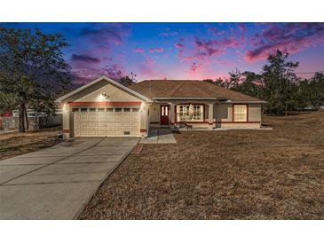 Charming one-story house with attached garage under sunset at 12059 Deep Creek Dr, Spring Hill, FL 34609