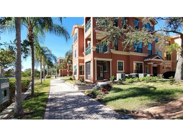 Building exterior showcasing a pathway, landscaping, and waterfront views at 2757 Via Cipriani # 1114A, Clearwater, FL 33764