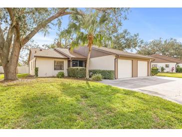 Single-story house with two-car garage and lush landscaping at 4654 Oak Hill Ln # 38, Sarasota, FL 34232