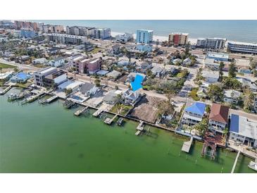 Waterfront home with private docks, beach access, and potential for new construction on adjacent lot at 14157 N Bayshore Dr, Madeira Beach, FL 33708