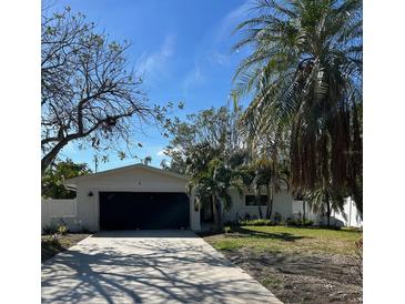 Updated single-story home with a modern facade and a spacious driveway at 1836 Jersey Ne St, St Petersburg, FL 33703