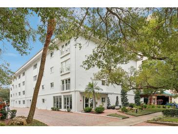 White three-story building with lush landscaping and parking at 210 5Th S Ave # 307, St Petersburg, FL 33701