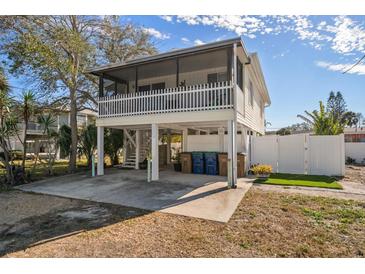 Elevated beach cottage with a porch and fenced yard at 2215 1St St # A & B, Indian Rocks Beach, FL 33785