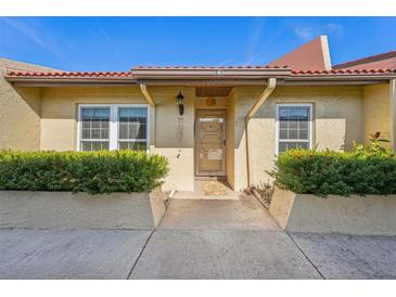 Inviting condo exterior featuring a well-maintained front entrance and landscaping at 7200 Ulmerton Rd # E3, Largo, FL 33771
