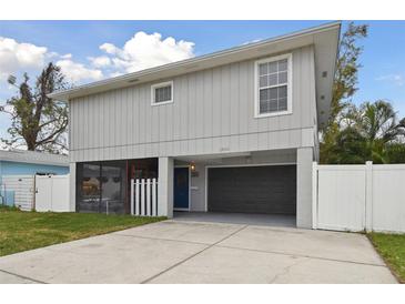 Two-story house with gray siding, gray garage door, and a blue front door at 1866 Michigan Ne Ave, St Petersburg, FL 33703