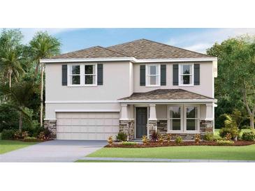 Two-story house with stone accents and a two-car garage at 3550 Thistle Bank Ct, Plant City, FL 33565