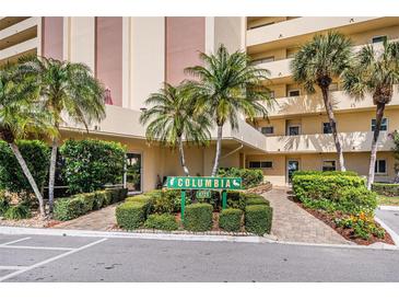 Condo building exterior showcasing manicured landscaping and inviting entrance at 4725 Cove Cir # 211, St Petersburg, FL 33708