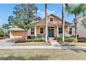 Inviting house exterior with a charming front porch and landscaping at 5253 Brighton Shore Dr, Apollo Beach, FL 33572