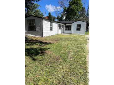 Charming white house with black trim and a spacious yard at 8465 N Tobay Rd, St Petersburg, FL 33702