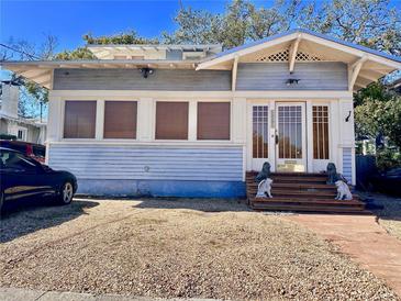 Charming light blue house with a front porch and decorative lion statues at 1203 S Gunby Ave, Tampa, FL 33606