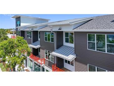 Modern building exterior with gray siding, orange accents, and large windows at 13 29Th N St, St Petersburg, FL 33713