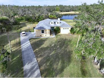 Aerial view of the home, highlighting its driveway and landscaping at 13653 Heritage Way, Sarasota, FL 34240