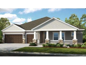 One-story home with two-car garage and attractive landscaping at 2471 Overfalls Pl, Wesley Chapel, FL 33543