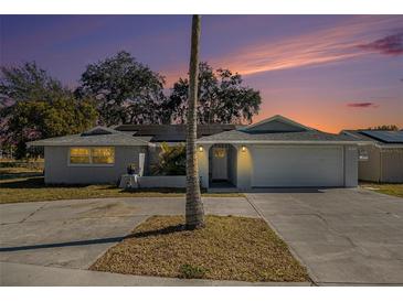 Updated single-story home with a large driveway and landscaped yard at 11828 Bingham Dr, Port Richey, FL 34668