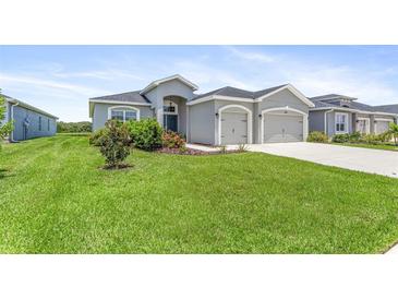 Two-car garage, well-manicured lawn, and attractive landscaping at 16120 67Th E Ct, Parrish, FL 34219