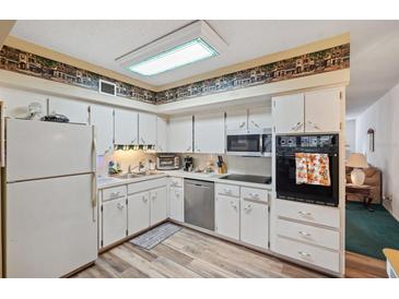 Bright kitchen featuring stainless steel appliances and wood-look flooring at 2430 Florentine Way # 38, Clearwater, FL 33763