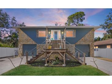 Stunning two-story home with stone accents and a charming front porch at 7418 Bay Dr, Tampa, FL 33635