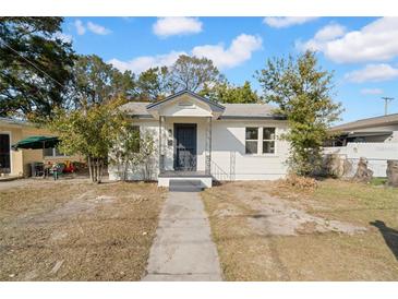 Charming bungalow with a well-maintained front yard and walkway at 1306 E 24Th Ave, Tampa, FL 33605