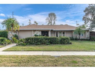 Attractive single-story home with well-manicured lawn and landscaping at 14022 Passage Way, Seminole, FL 33776