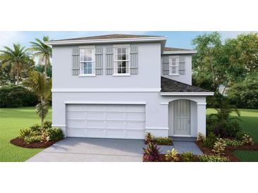 Two-story house with gray siding, gray shutters, and a two-car garage at 36101 Sunflower Hill Dr, Zephyrhills, FL 33541