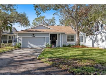 Cute light blue house with a nicely landscaped lawn and driveway at 764 Captiva Ne Ct, St Petersburg, FL 33702