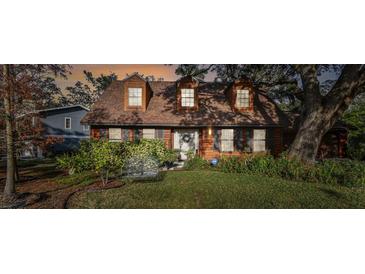 Inviting home exterior with wood siding and landscaped yard at 1455 Briarwood Ct, Safety Harbor, FL 34695