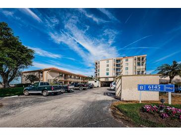 Condo building with parking and waterfront landscaping at 6145 Sun Blvd # 103, St Petersburg, FL 33715