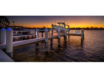 Private dock with boat lift, illuminated at sunset at 743 Chesapeake Dr, Tarpon Springs, FL 34689