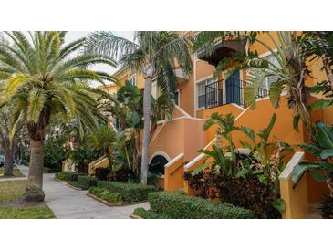 Building exterior with a walkway and tropical landscaping at 200 4Th S Ave # 139, St Petersburg, FL 33701