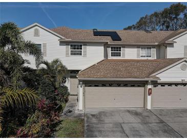 Two-story house with a two-car garage and solar panels at 3145 Meta Ct, Largo, FL 33771