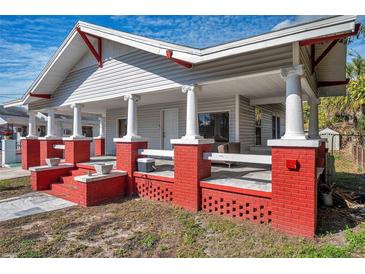 Charming house with a large front porch and red brick accents at 1318 E Louise Ave, Tampa, FL 33603