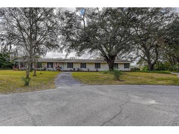 Ranch style home with mature landscaping and large front yard at 1760 Kenesaw Ln, Clearwater, FL 33765