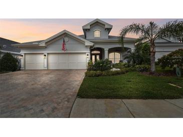 Stunning two-story home with a three-car garage and landscaped yard at 23 Concord Dr, Dunedin, FL 34698