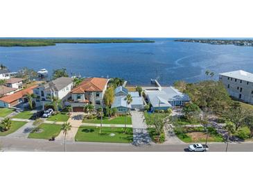 Aerial view of waterfront home with private dock and lush landscaping at 6323 Bayou Grande Ne Blvd, St Petersburg, FL 33702