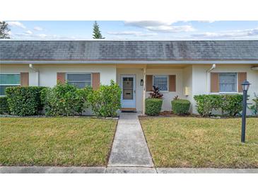 Inviting exterior of a ranch-style home featuring a walkway and landscaping at 1421 Normandy Park Dr # 2, Clearwater, FL 33756
