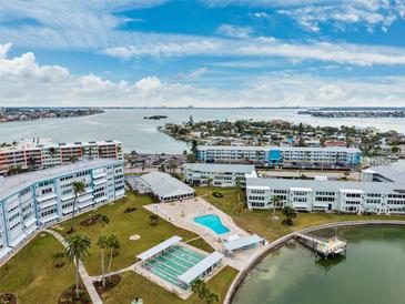 Aerial view of waterfront community with pool, shuffleboard, and boat dock at 1868 Shore S Dr # 209, South Pasadena, FL 33707