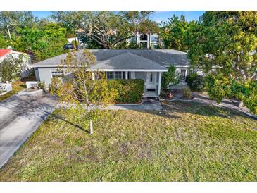 Single-story house with a spacious front yard and mature trees at 5971 52Nd N Ave, Kenneth City, FL 33709