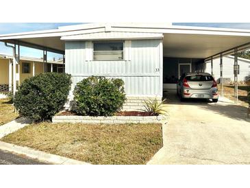 Mobile home with carport and landscaped yard at 9790 66Th N St # 33, Pinellas Park, FL 33782