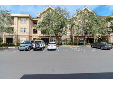 Tan multi-unit building with ample parking and landscaping at 1429 Villa Capri Cir # 306, Odessa, FL 33556