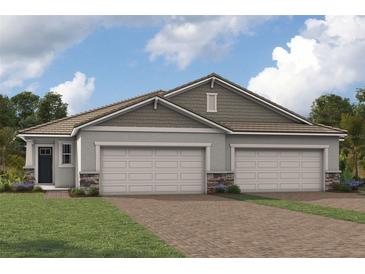 Two-story home with three-car garage and attractive landscaping at 18491 Green Garden Ct, Venice, FL 34293