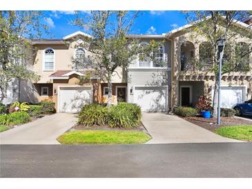Front view of charming townhouses with attached garages and lush landscaping at 310 Summer Clouds Pl, Brandon, FL 33511