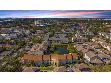 Aerial view of condo community with lake, showcasing building and surrounding landscape at 13600 Egret Blvd # 204K, Clearwater, FL 33762